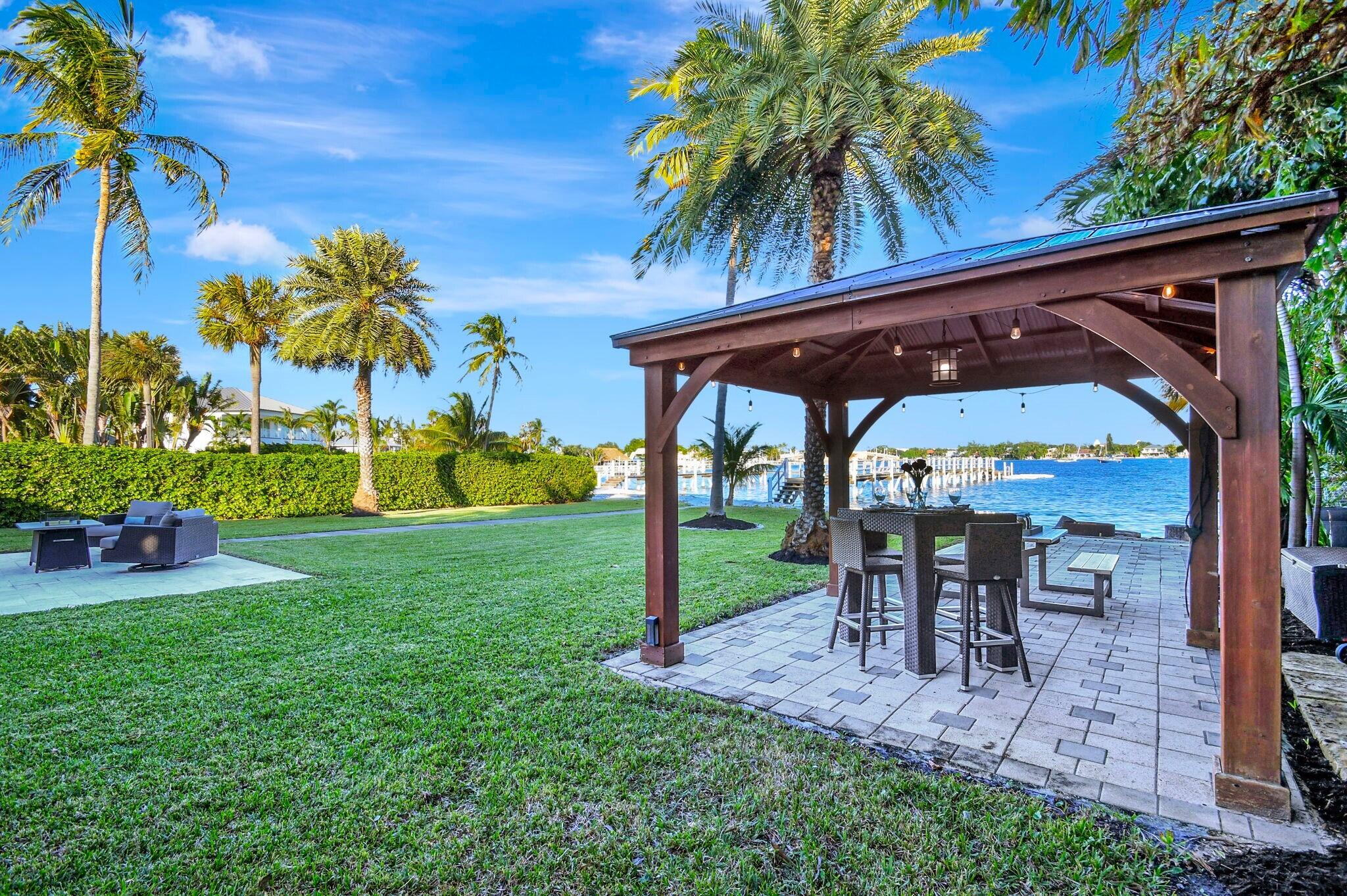 310 South Lake Drive Lantana, FL 33462 - Photo 44 of 65 a view of a backyard with a patio table and chairs