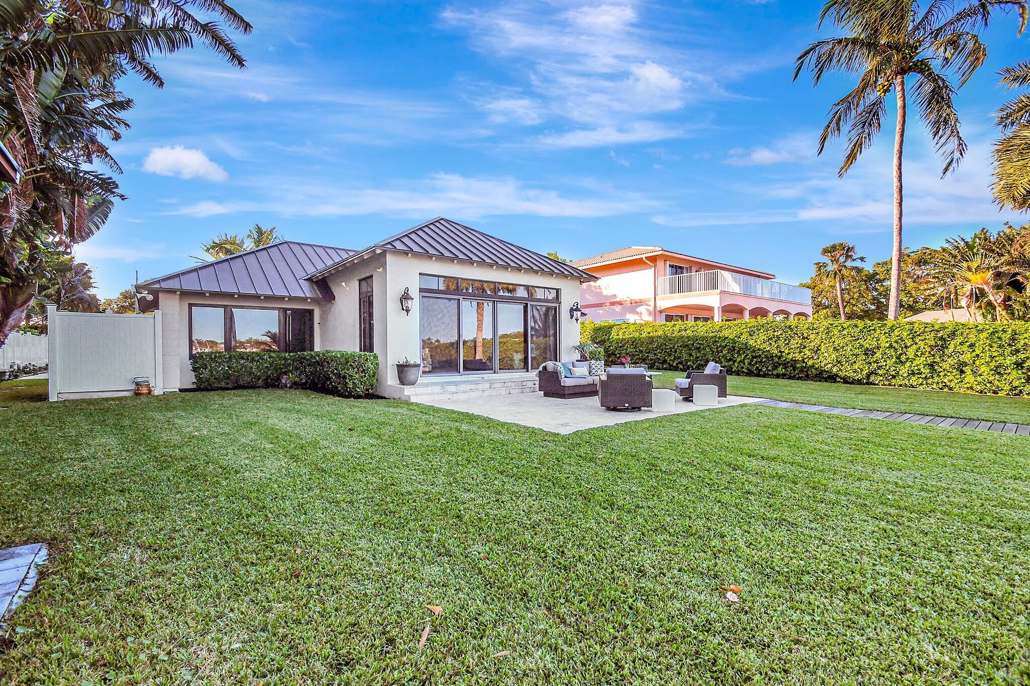 310 South Lake Drive Lantana, FL 33462 - Photo 46 of 65 a front view of a house with a yard