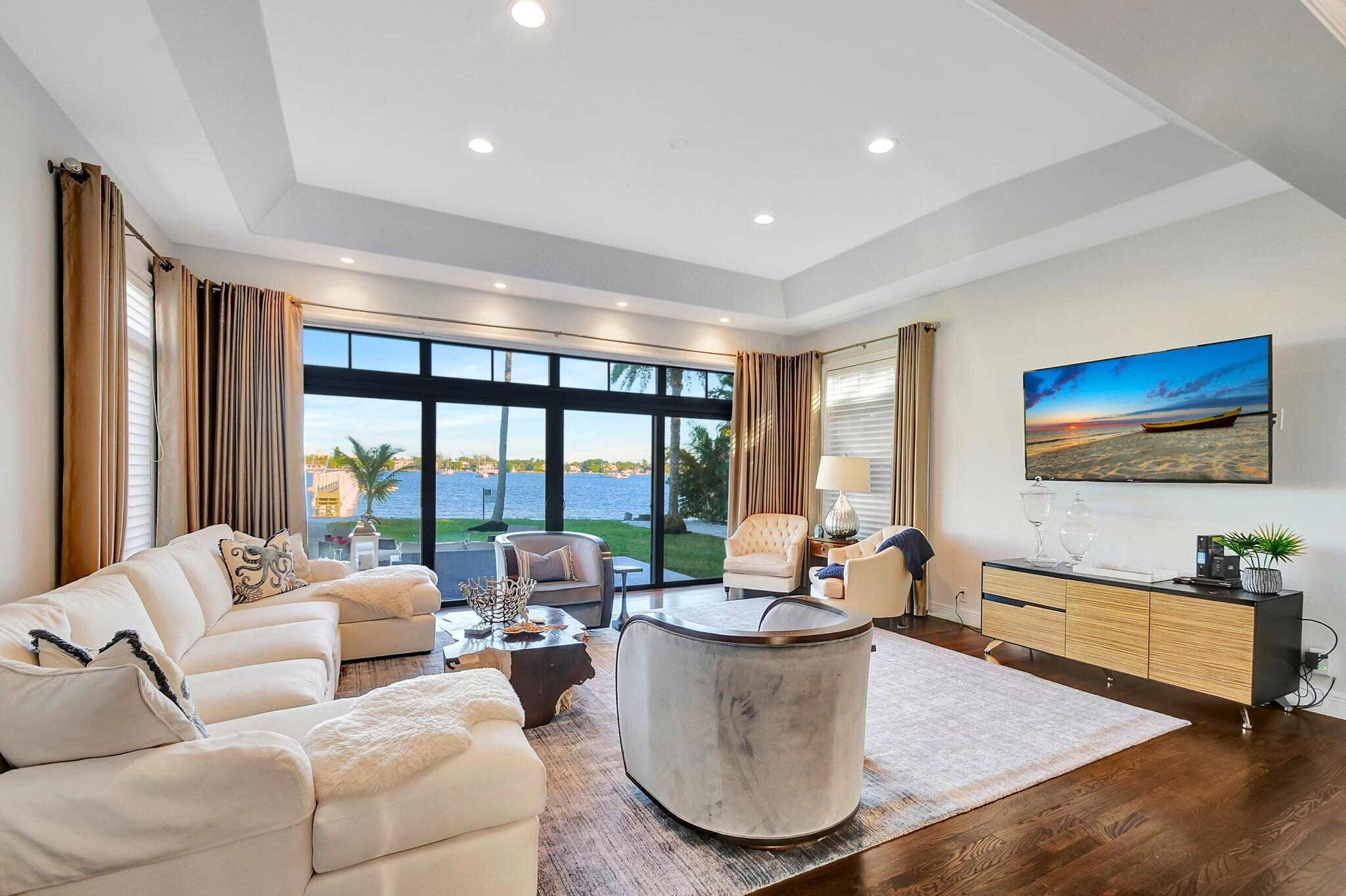 310 South Lake Drive Lantana, FL 33462 - Photo 5 of 65 a living room with furniture and a flat screen tv