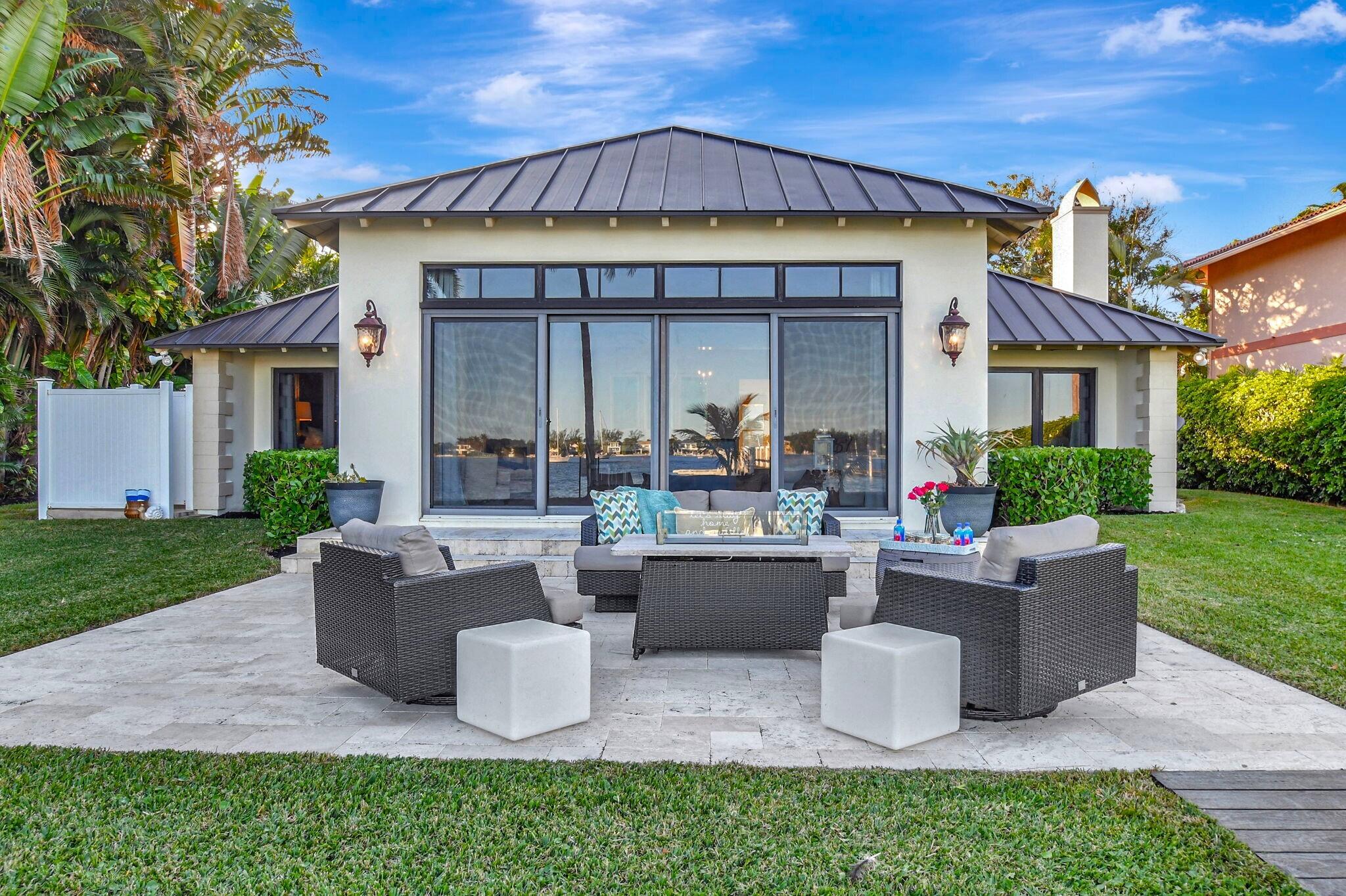 310 South Lake Drive Lantana, FL 33462 - Photo 6 of 65 a front view of a house with patio