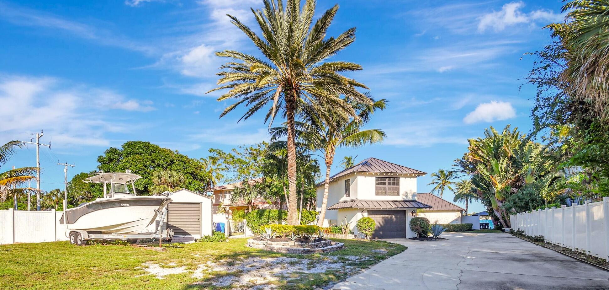 310 South Lake Drive Lantana, FL 33462 - Photo 9 of 65 a front view of a house with a yard and garage