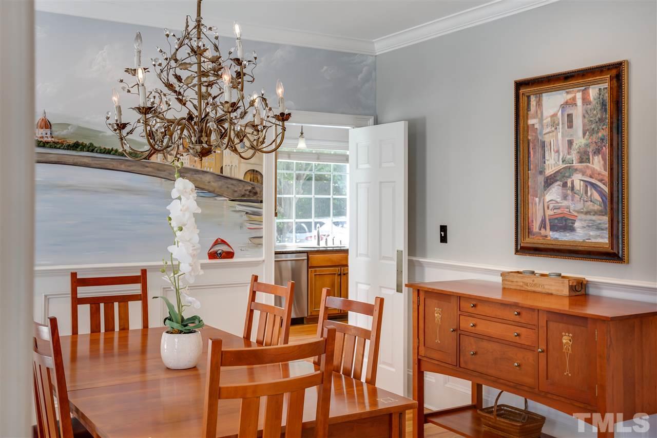 1005 Oak Creek Road Raleigh, NC 27615 - Photo 11 of 30 a dining room with furniture a chandelier and window