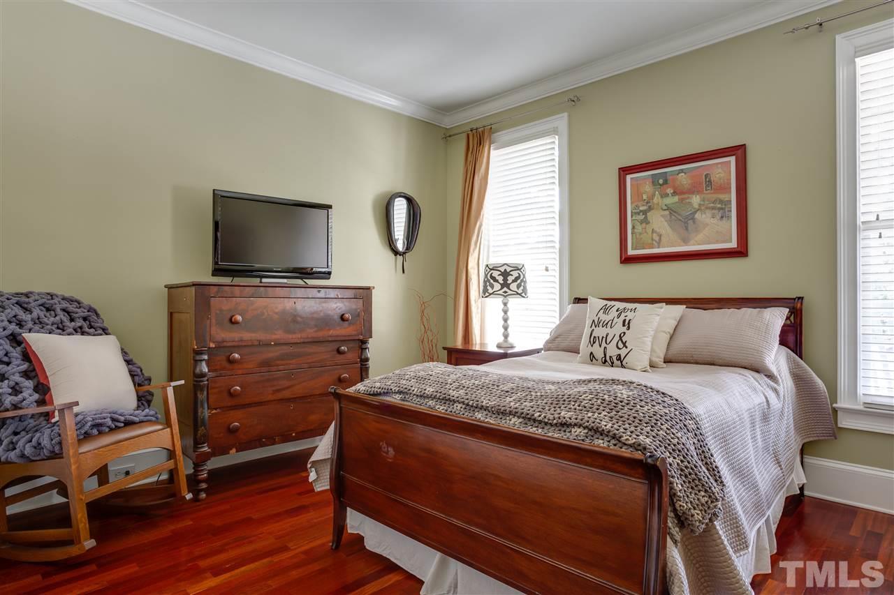 1005 Oak Creek Road Raleigh, NC 27615 - Photo 12 of 30 a bedroom with a bed and a flat screen tv