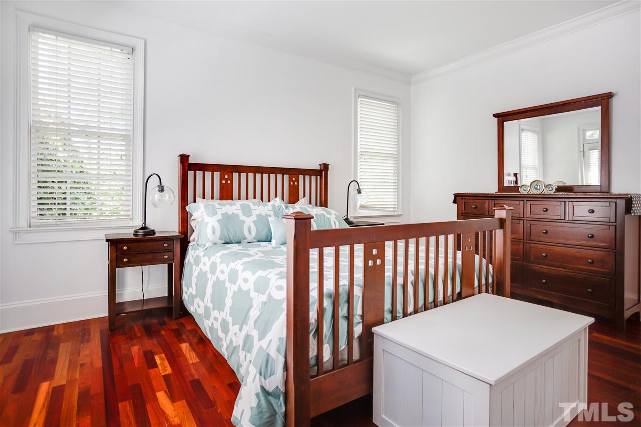 1005 Oak Creek Road Raleigh, NC 27615 - Photo 15 of 30 a bedroom with a bed and wooden floor