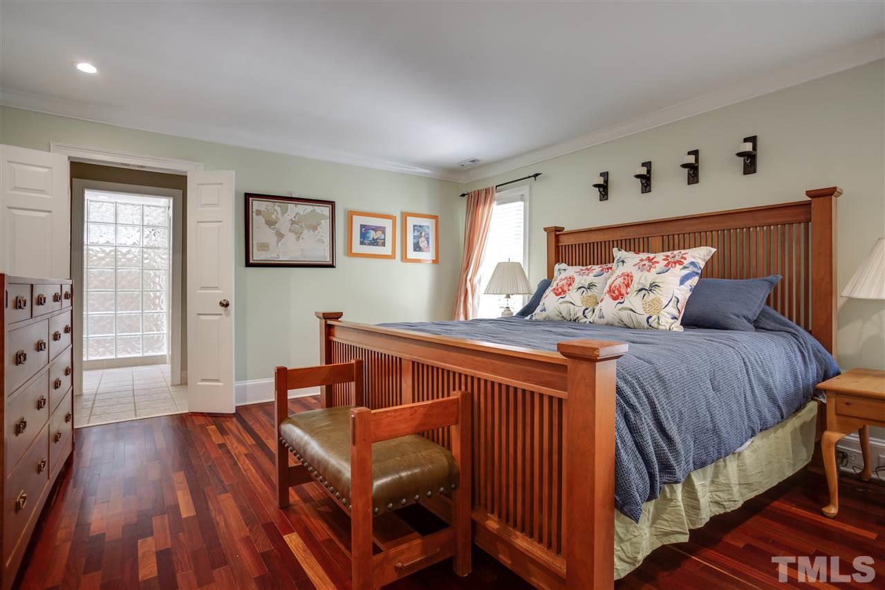 1005 Oak Creek Road Raleigh, NC 27615 - Photo 16 of 30 a bedroom with bed and wooden floor