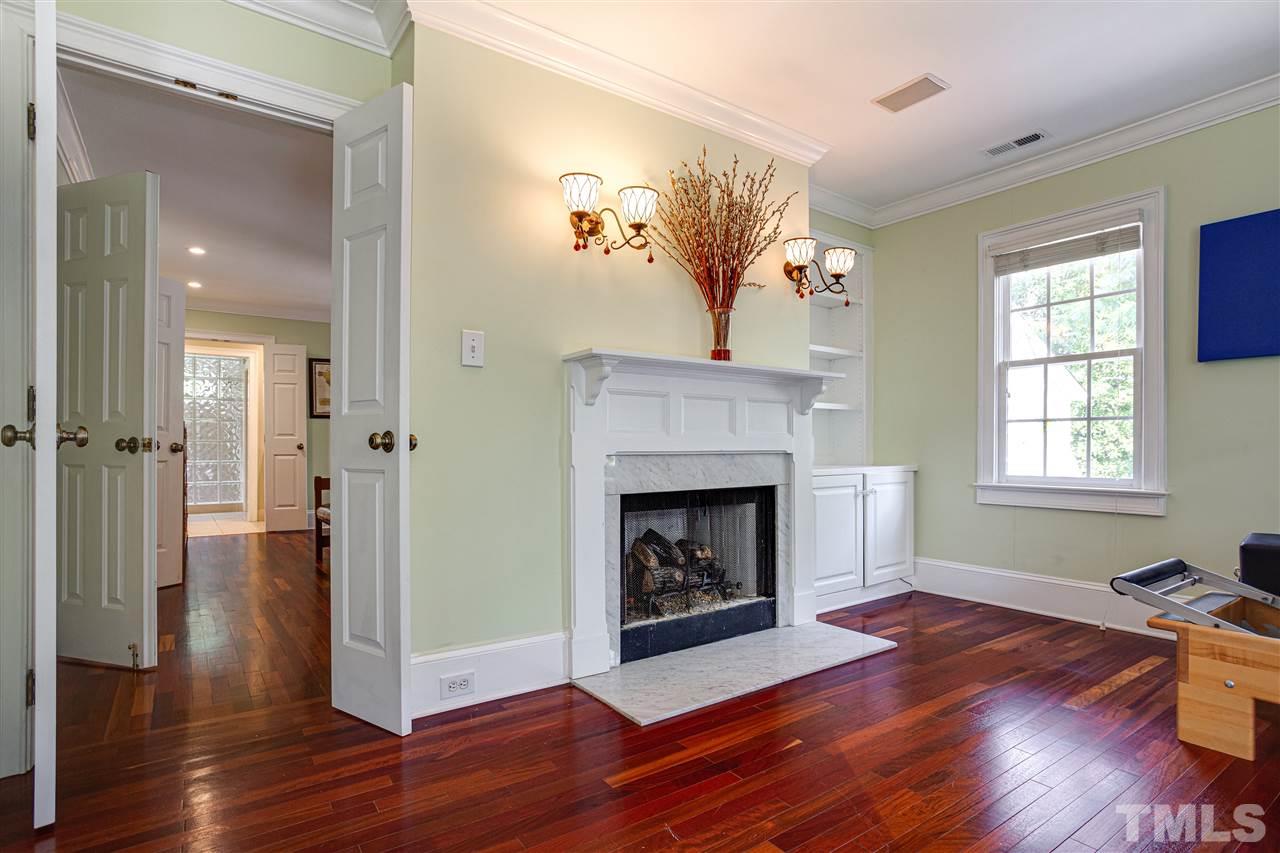 1005 Oak Creek Road Raleigh, NC 27615 - Photo 21 of 30 a view of a livingroom with wooden floor and a fireplace