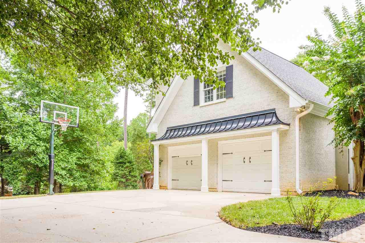 1005 Oak Creek Road Raleigh, NC 27615 - Photo 23 of 30 a front view of a house with garden