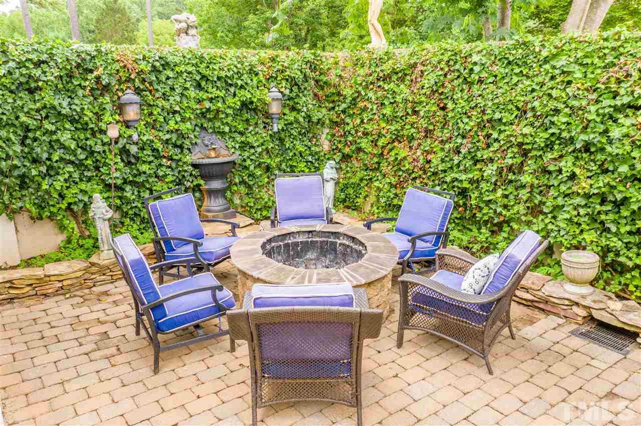 1005 Oak Creek Road Raleigh, NC 27615 - Photo 25 of 30 a backyard of a house with outdoor seating