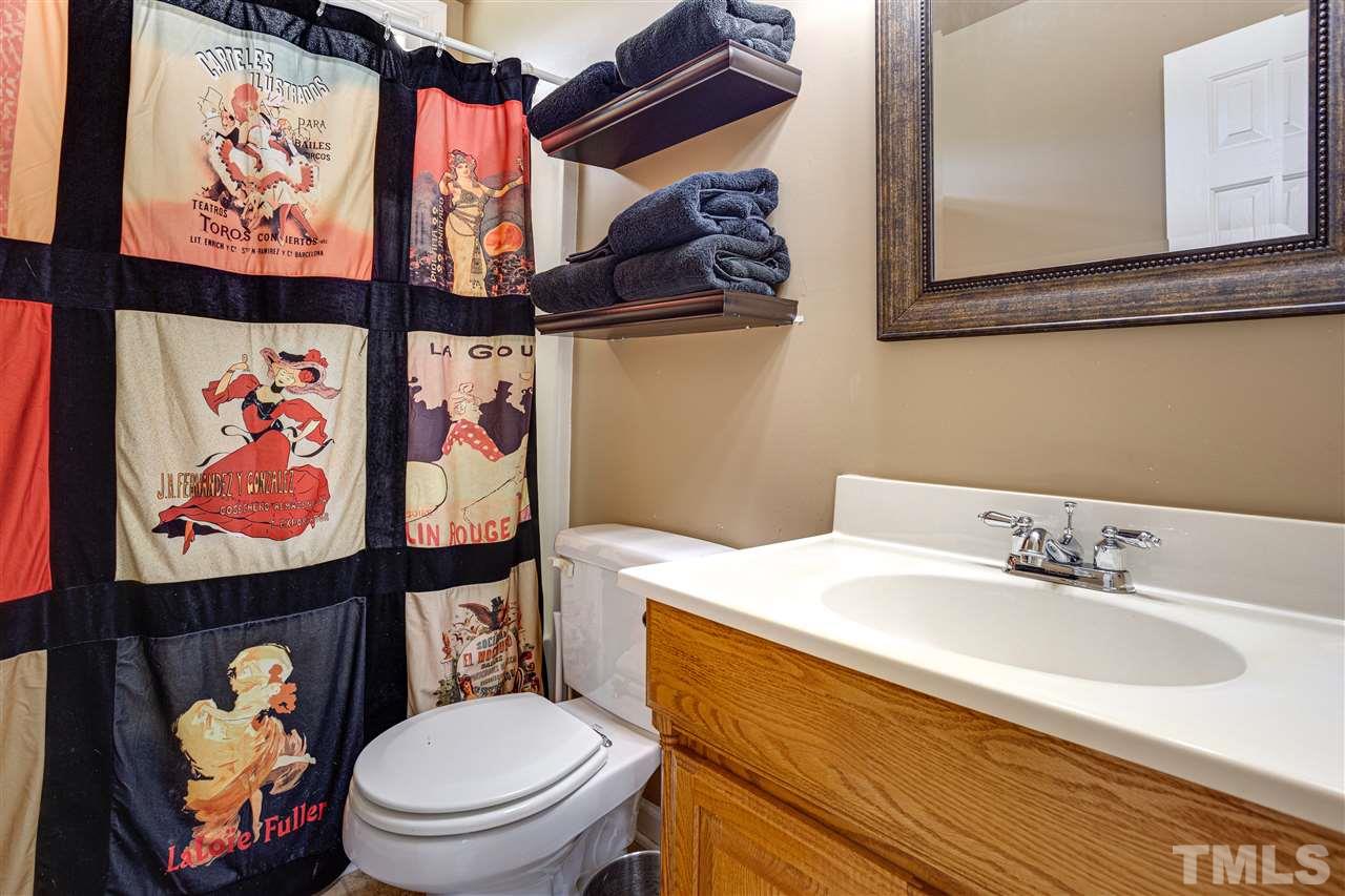 1005 Oak Creek Road Raleigh, NC 27615 - Photo 28 of 30 a bathroom with a sink mirror and toilet