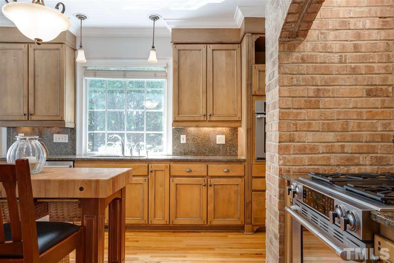 1005 Oak Creek Road Raleigh, NC 27615 - Photo 9 of 30 a kitchen with a sink cabinets and window