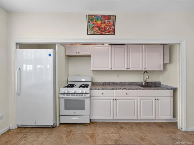 a kitchen with granite countertop a stove a sink and a granite counter tops