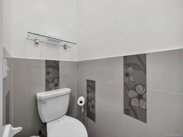 a white toilet sitting next to a bathroom sink