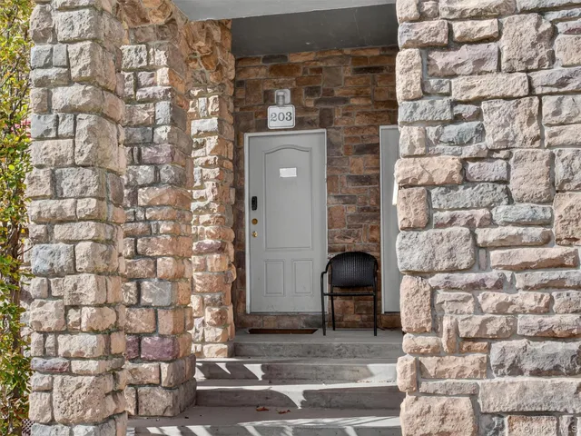 a front view of a house with a brick wall