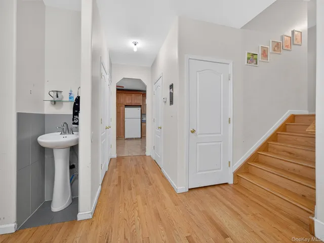 a view of a hallway with wooden floor and staircase