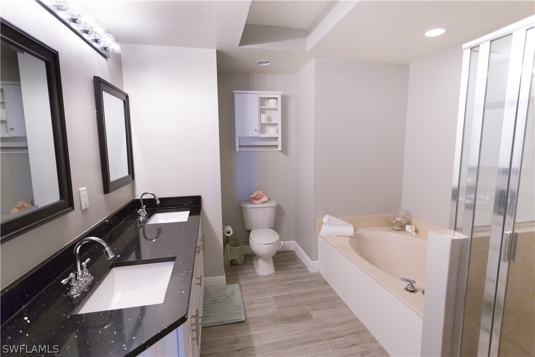 2745 First Street, Unit 1306 Fort Myers, FL 33916 - Photo 15 of 34 a bathroom with a sink a toilet and mirror