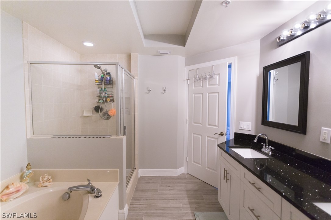 2745 First Street, Unit 1306 Fort Myers, FL 33916 - Photo 16 of 34 a bathroom with a granite countertop sink a shower and a mirror