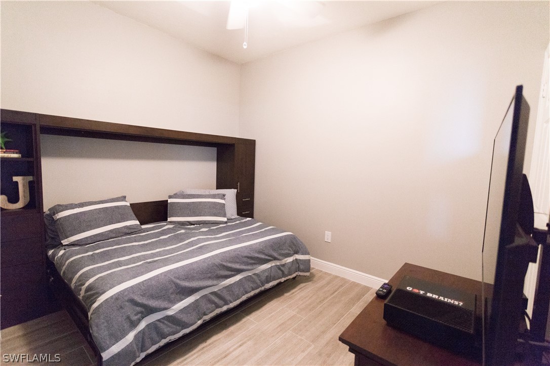 2745 First Street, Unit 1306 Fort Myers, FL 33916 - Photo 17 of 34 a bedroom with a bed and a chair