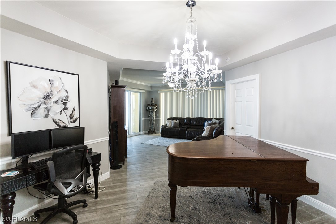 2745 First Street, Unit 1306 Fort Myers, FL 33916 - Photo 22 of 34 a view of a dining room with furniture and chandelier