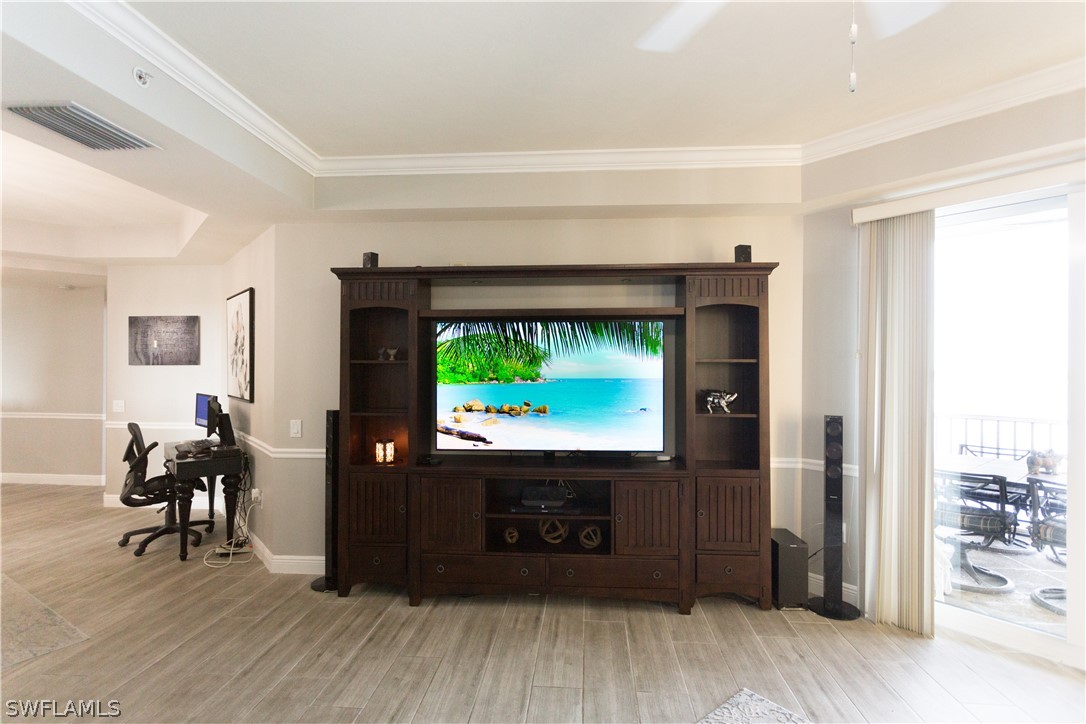 2745 First Street, Unit 1306 Fort Myers, FL 33916 - Photo 7 of 34 a living room with furniture and a flat screen tv