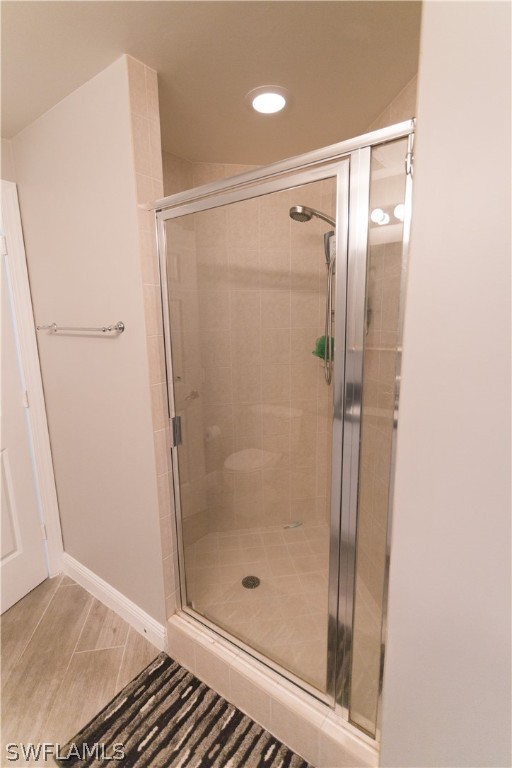 2745 First Street, Unit 1306 Fort Myers, FL 33916 - Photo 9 of 34 a bathroom with a glass shower door