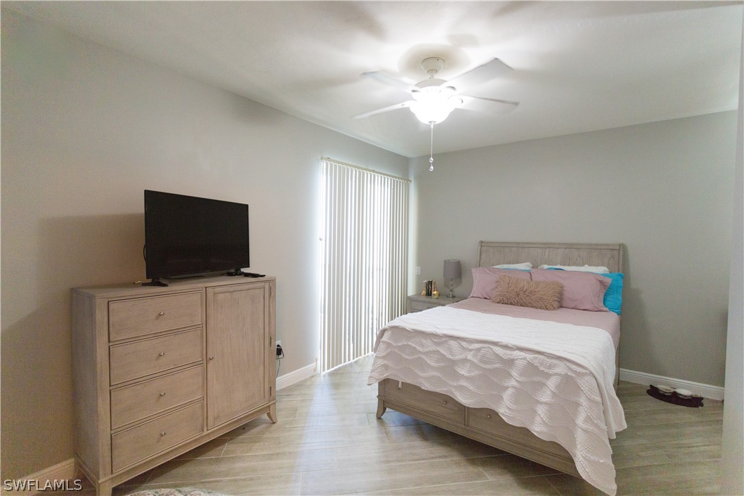 2745 First Street, Unit 1306 Fort Myers, FL 33916 - Photo 10 of 34 a bedroom with a bed and a flat screen tv