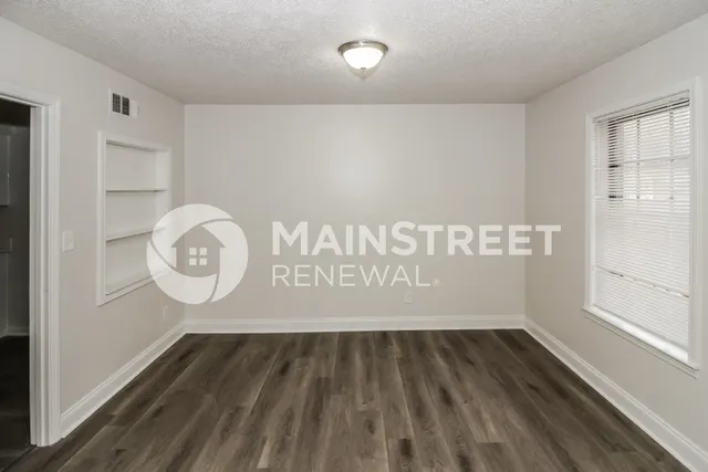 a view of a room with wooden floor