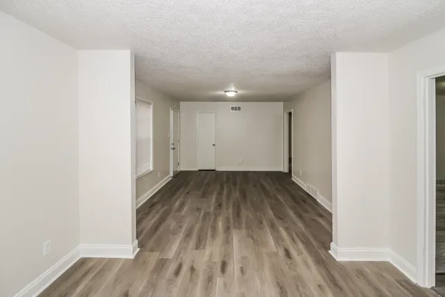 a view of a room with wooden floor