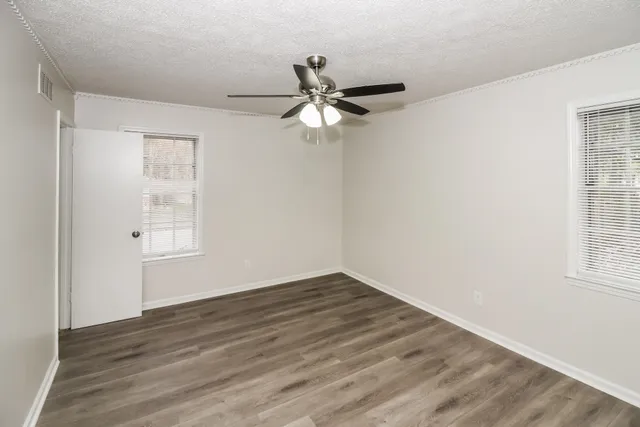 wooden floor in an empty room with a window