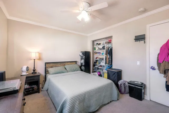 a bedroom with a bed and a chandelier