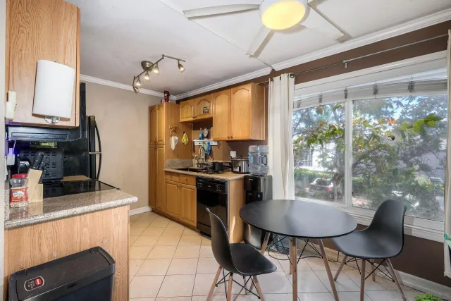 a kitchen with a table and chairs in it