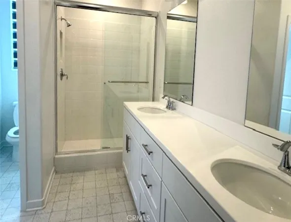 a bathroom with a granite countertop sink a mirror and a bathtub