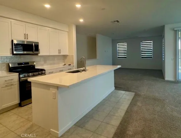 a kitchen that has a sink and a stove top oven