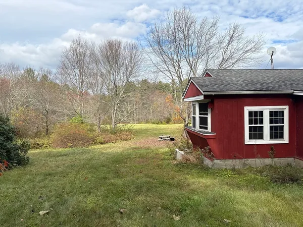 a backyard of a house with yard and trampoline
