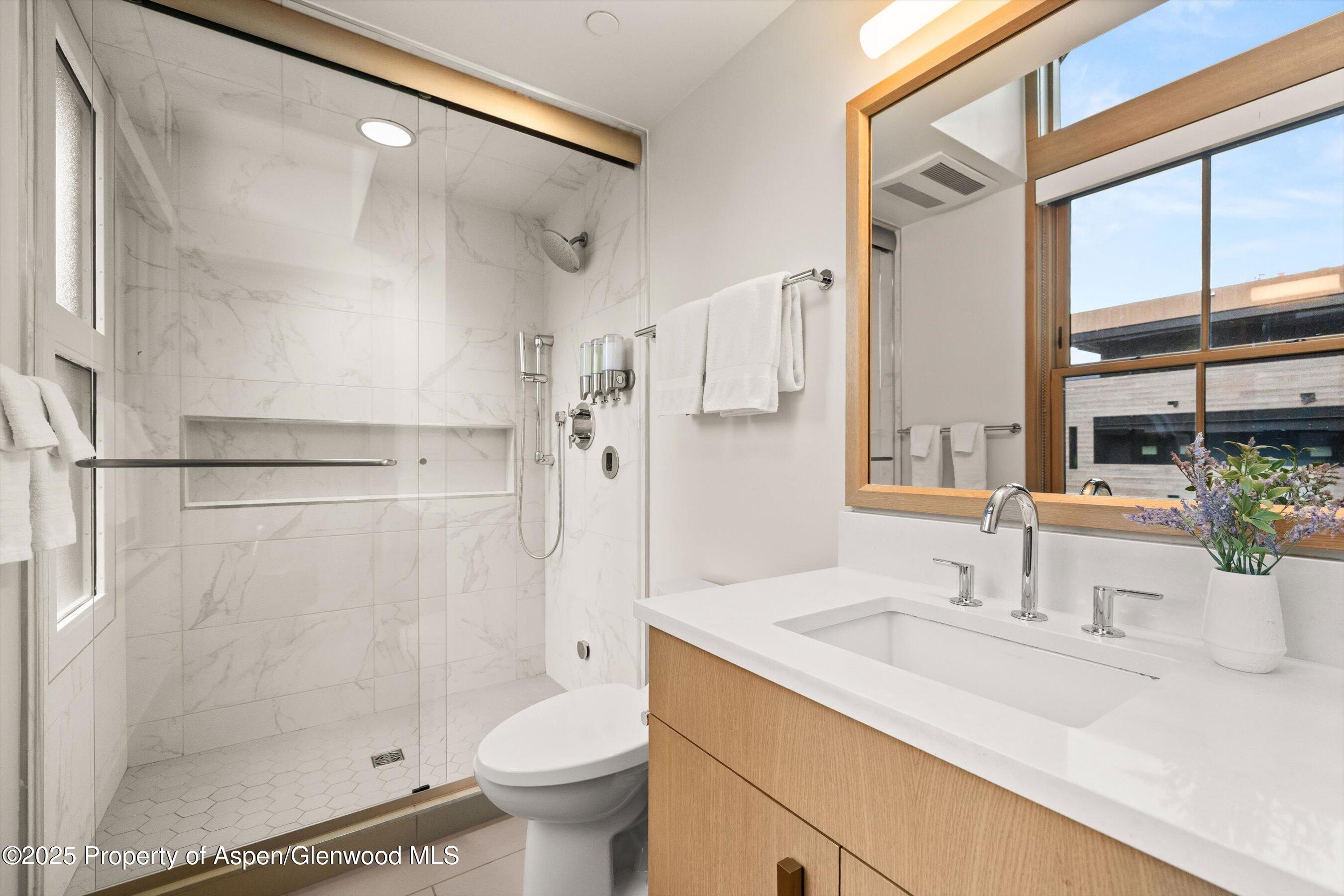 122 West Main Street Aspen, CO 81611 - Photo 14 of 58 a bathroom with a sink toilet and shower