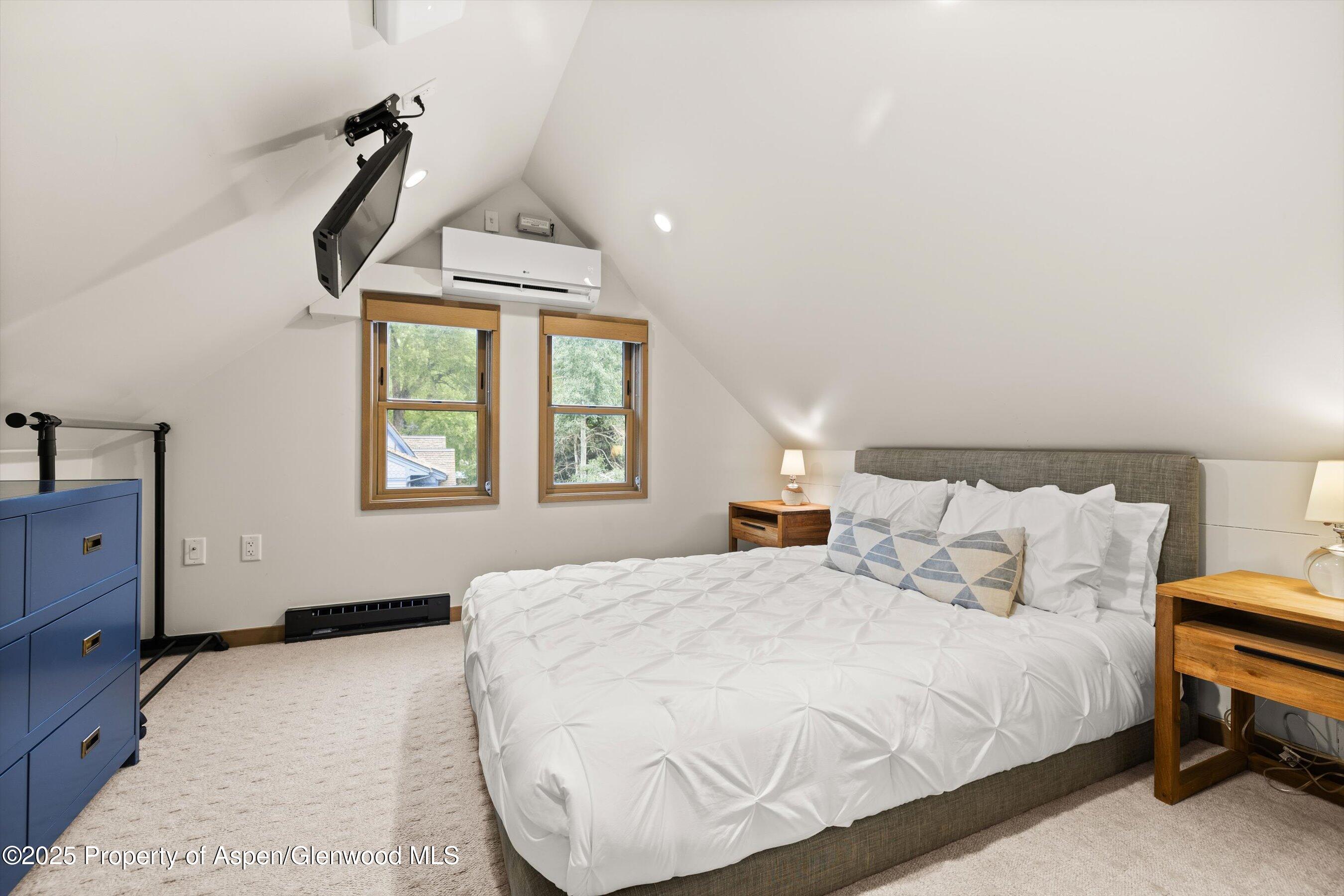 122 West Main Street Aspen, CO 81611 - Photo 21 of 58 a bedroom with a bed and window