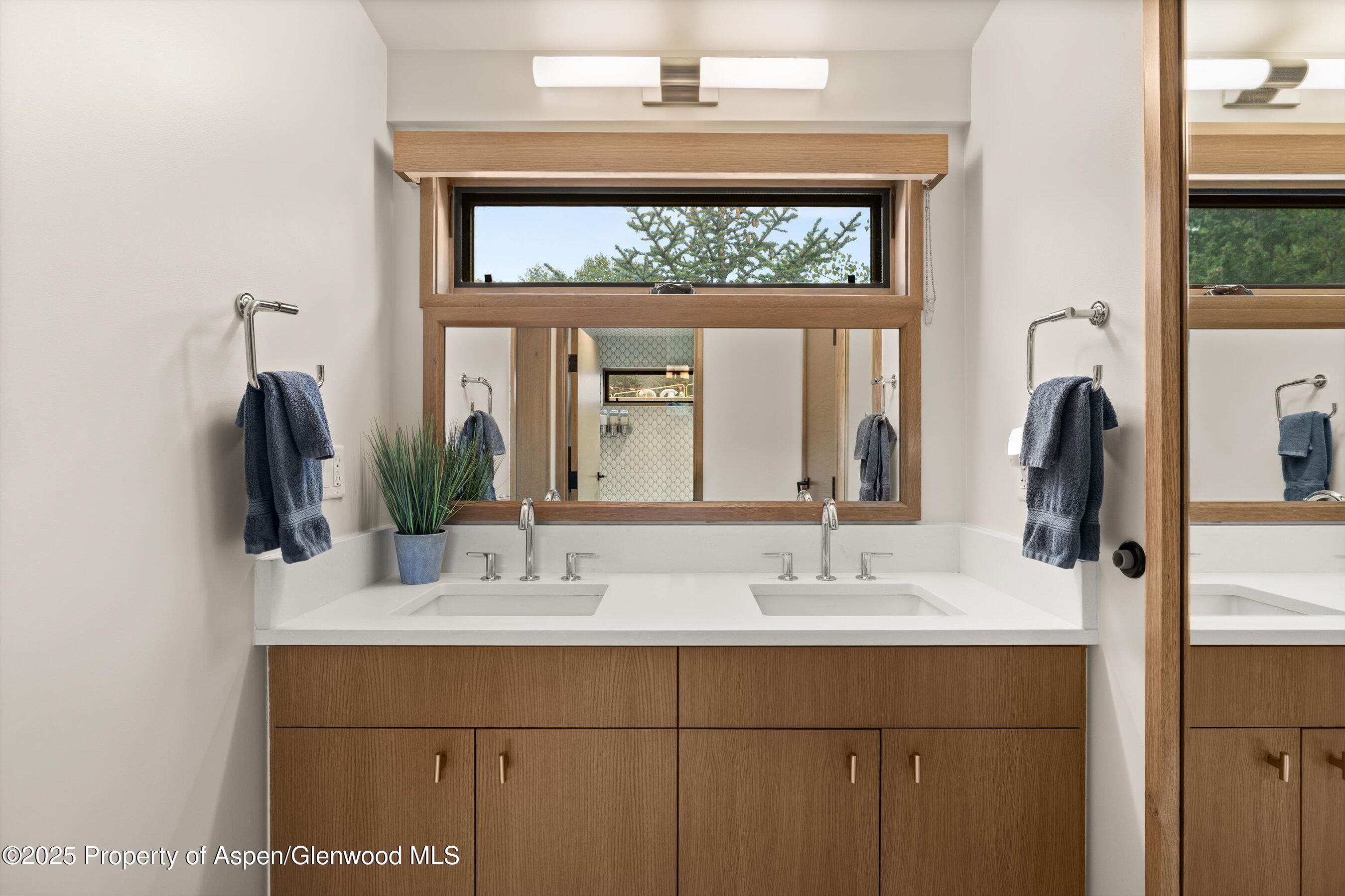 122 West Main Street Aspen, CO 81611 - Photo 22 of 58 a bathroom with a sink and a mirror