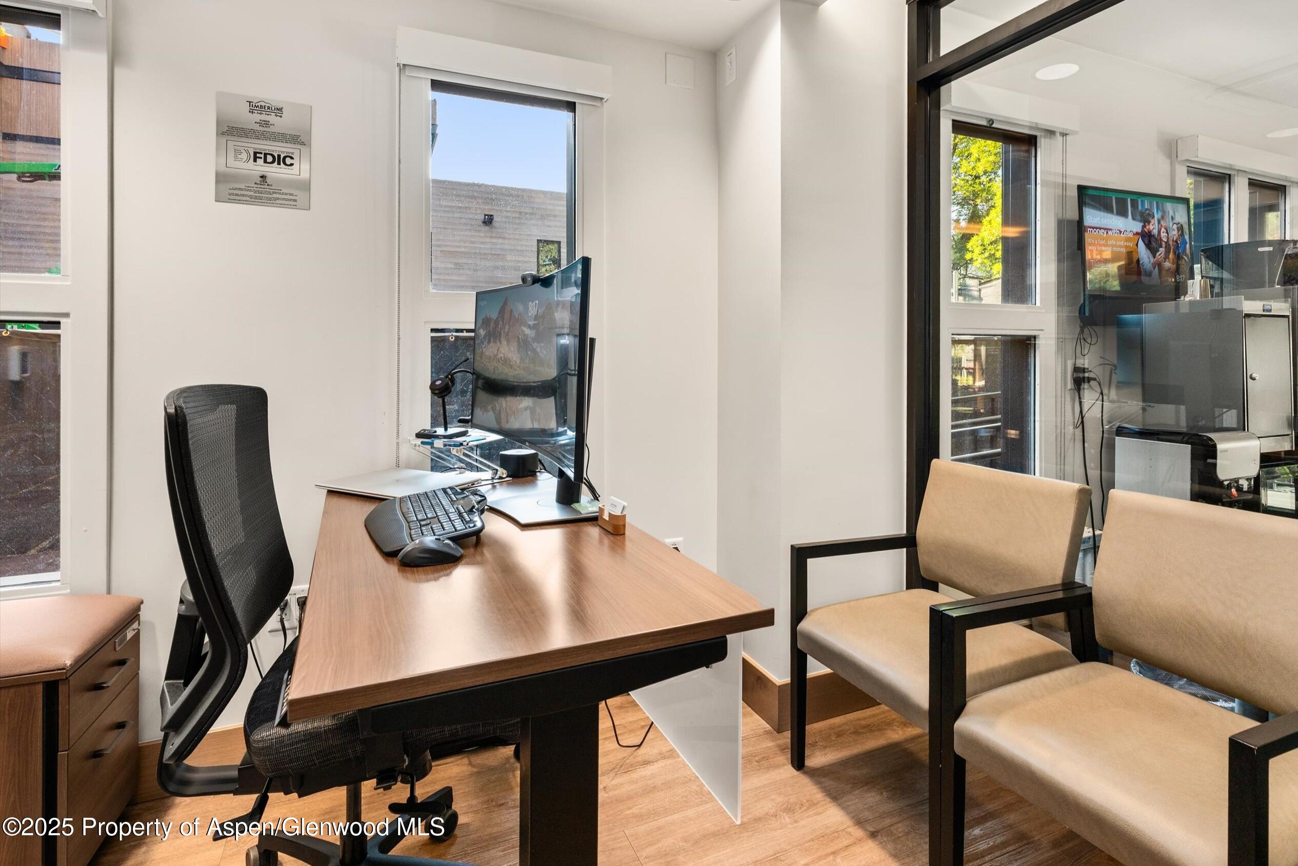 122 West Main Street Aspen, CO 81611 - Photo 34 of 58 a view of a workspace with furniture and wooden floor
