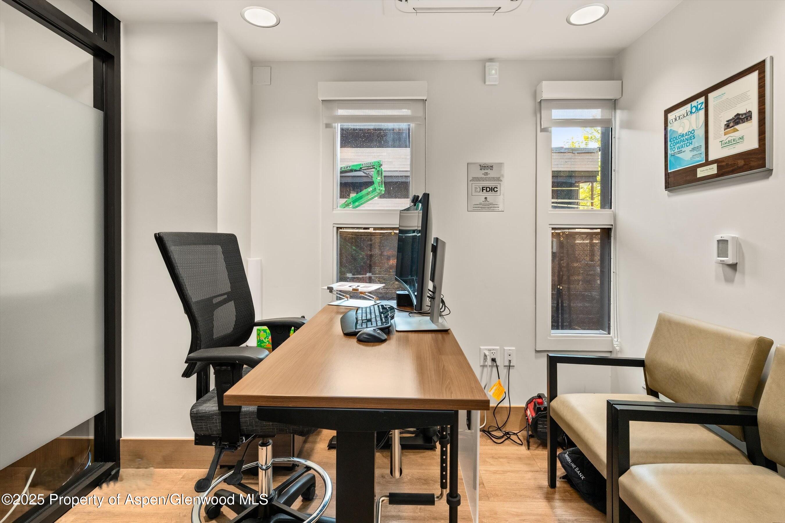 122 West Main Street Aspen, CO 81611 - Photo 36 of 58 a view of a workspace with furniture and wooden floor