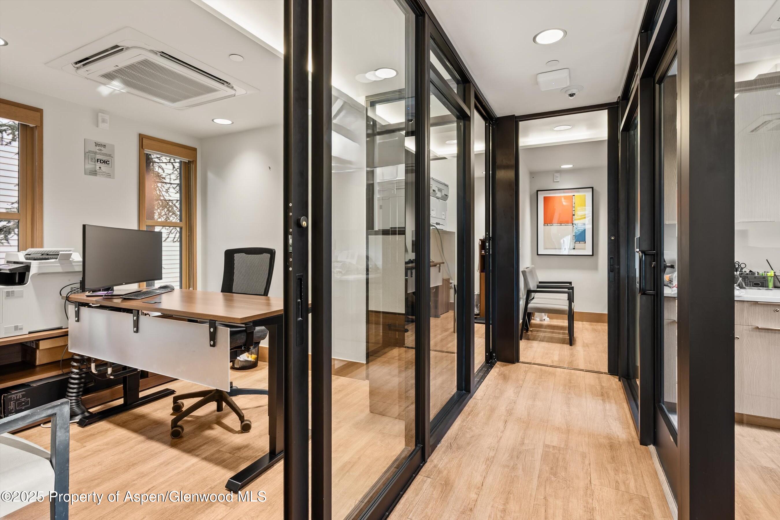 122 West Main Street Aspen, CO 81611 - Photo 42 of 58 a view of a workspace with furniture and a window