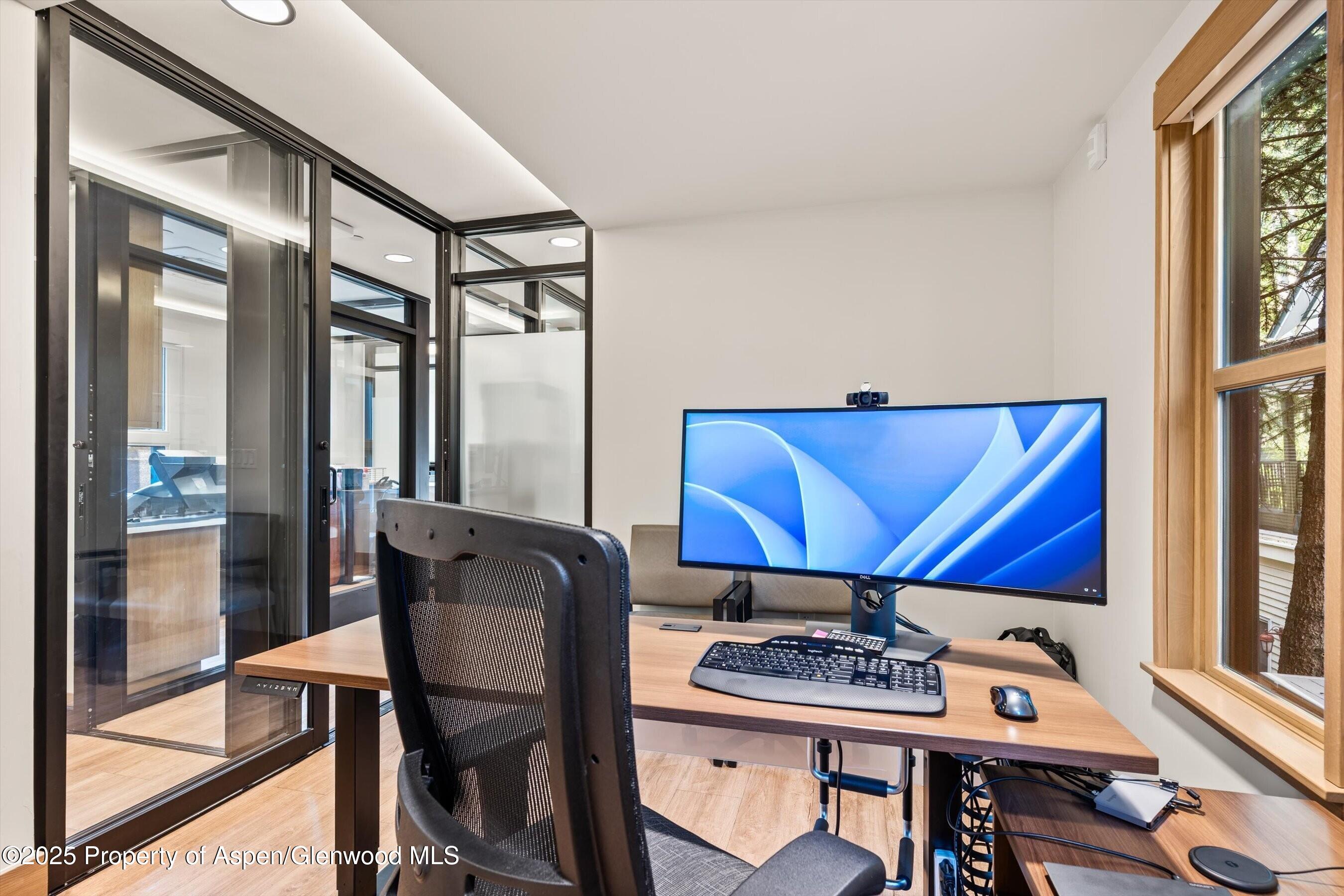122 West Main Street Aspen, CO 81611 - Photo 44 of 58 a view of a workspace with furniture and window