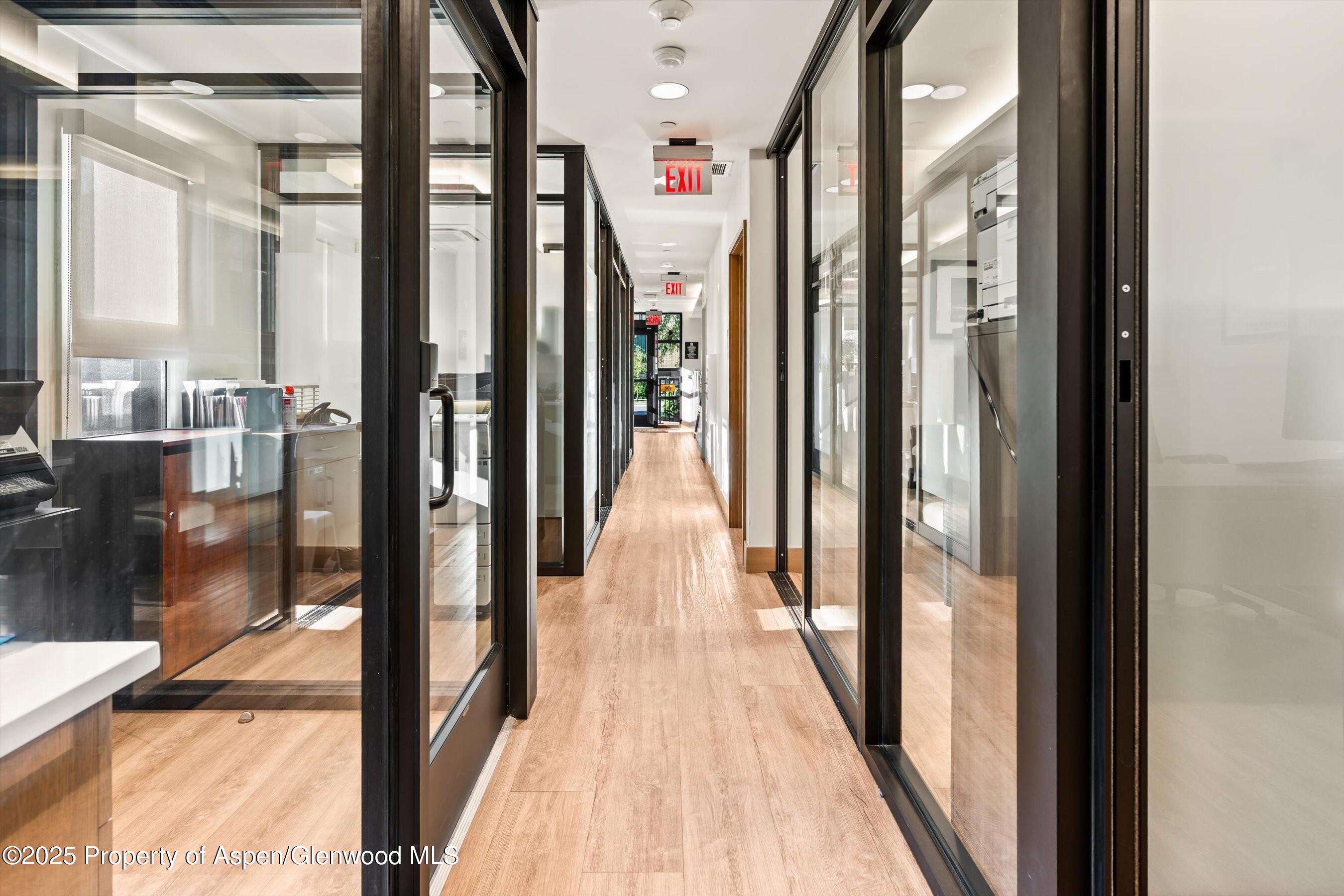 122 West Main Street Aspen, CO 81611 - Photo 45 of 58 a view of a hallway with wooden floor and windows