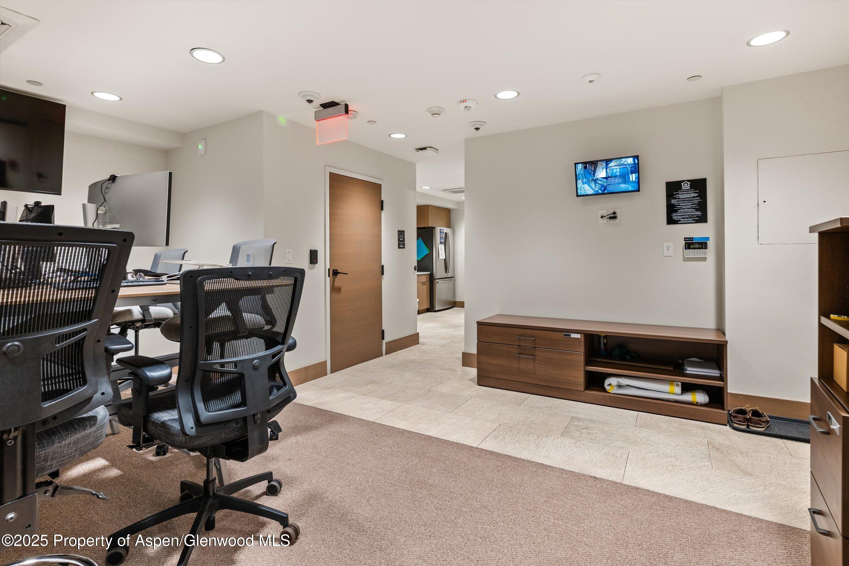 122 West Main Street Aspen, CO 81611 - Photo 50 of 58 a living room with furniture and a flat screen tv