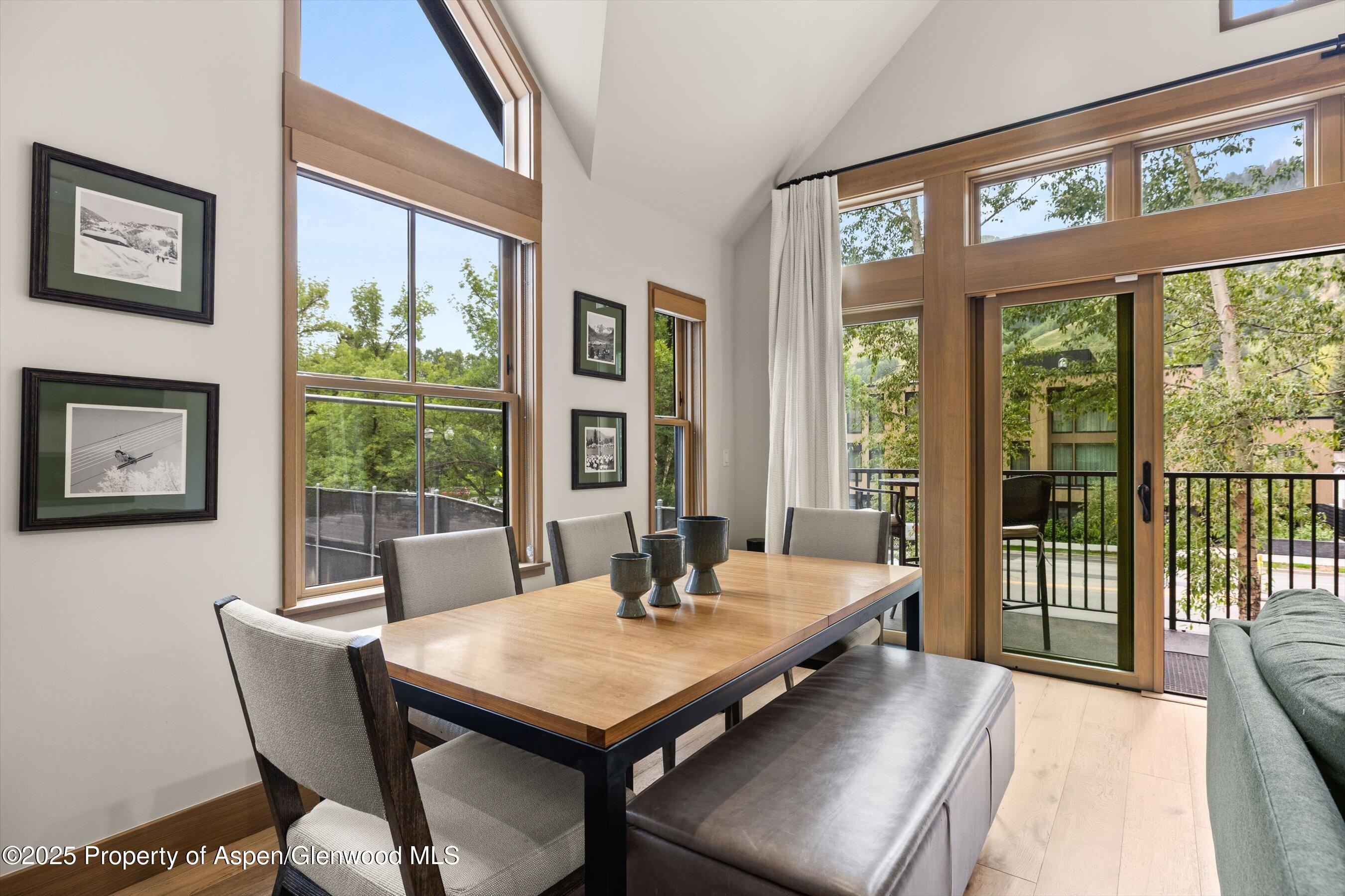 122 West Main Street Aspen, CO 81611 - Photo 6 of 58 a dining room with furniture a rug and a large window