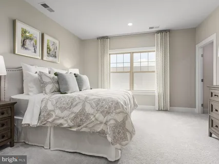 a spacious bedroom with a bed and glass window