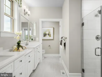 a spacious bathroom with a double vanity sink a mirror a shower and a bathtub