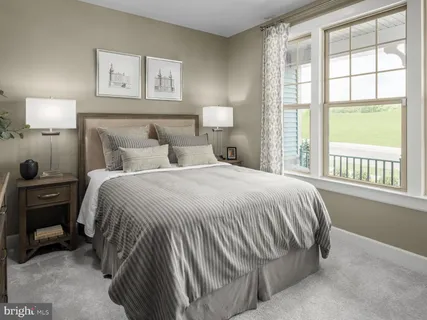 a bedroom with a bed and a lamp next to a window