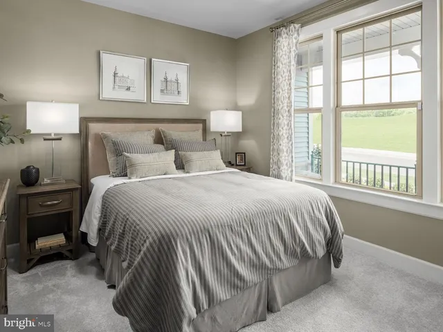 a bedroom with a bed and a lamp next to a window