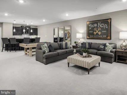 a living room with furniture and kitchen view