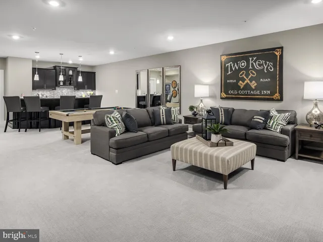 a living room with furniture and kitchen view