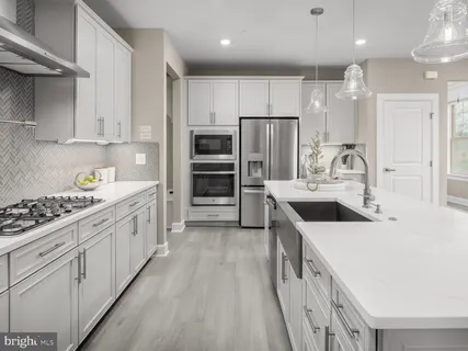 a kitchen with kitchen island a sink stove and refrigerator